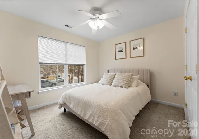 a bedroom with a large bed and a window