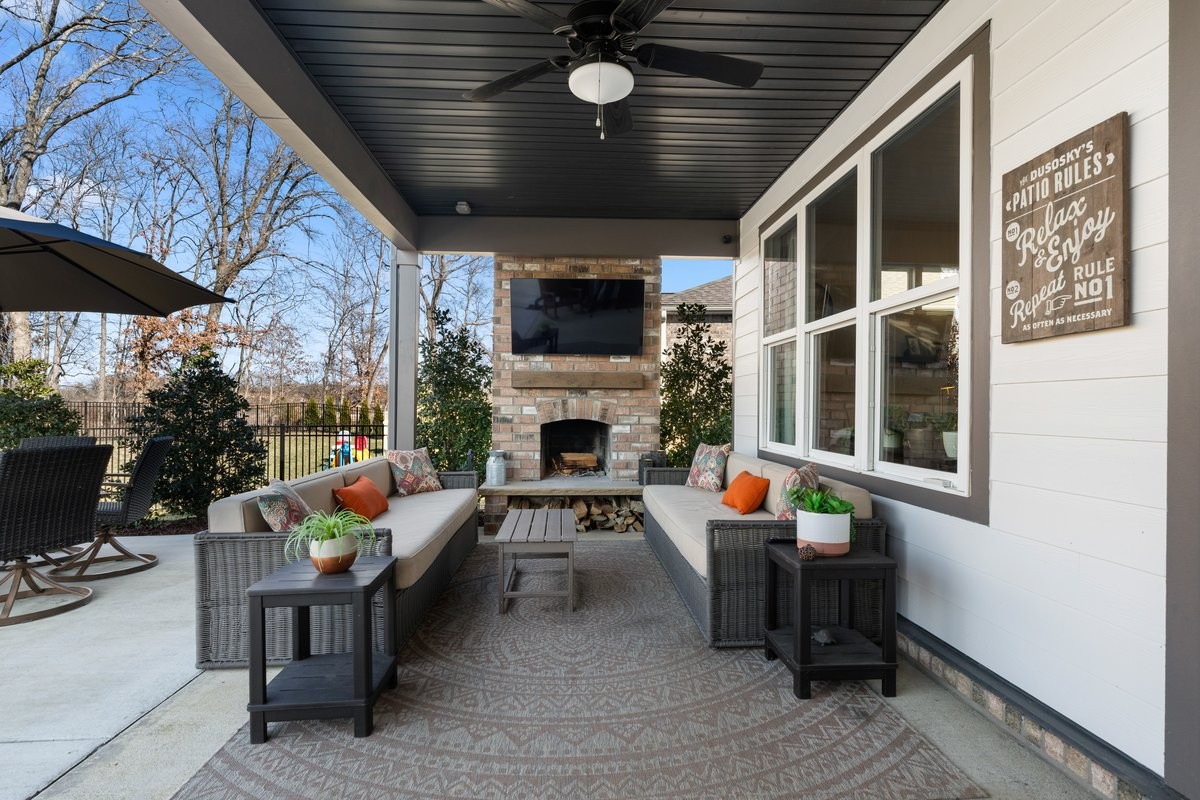 1049 Fallow Road Mount Juliet, TN 37122 - Photo 3 of 55 a living room with furniture a fireplace and a flat screen tv