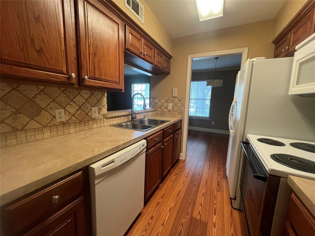 3730 Fairfield Avenue, Unit 129 Shreveport, LA 71104 - Photo 11 of 15 a kitchen with a sink a microwave cabinets and stainless steel appliances