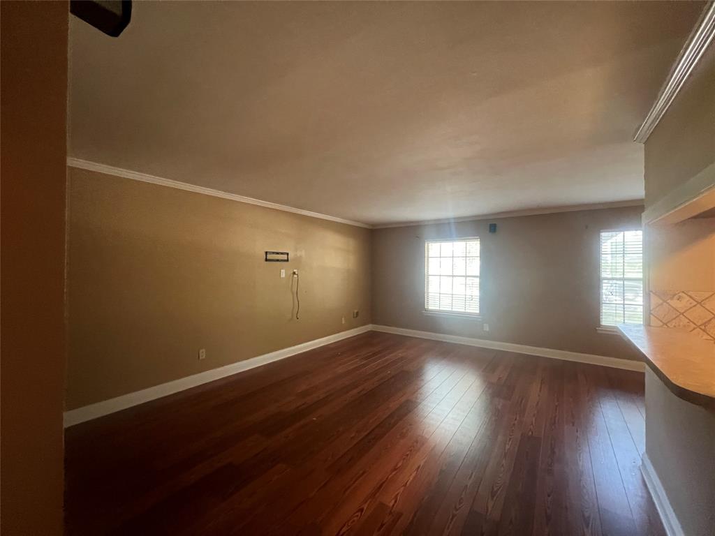 3730 Fairfield Avenue, Unit 129 Shreveport, LA 71104 - Photo 8 of 15 an empty room with wooden floor and windows