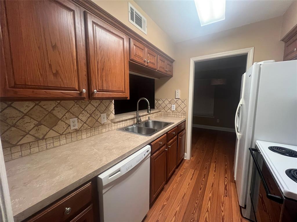 3730 Fairfield Avenue, Unit 129 Shreveport, LA 71104 - Photo 9 of 15 a kitchen with a sink a refrigerator and cabinets