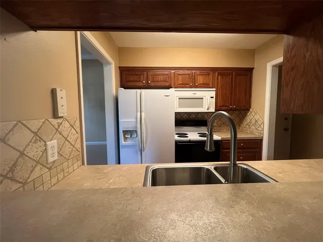 a kitchen with stainless steel appliances kitchen island a refrigerator sink and stove