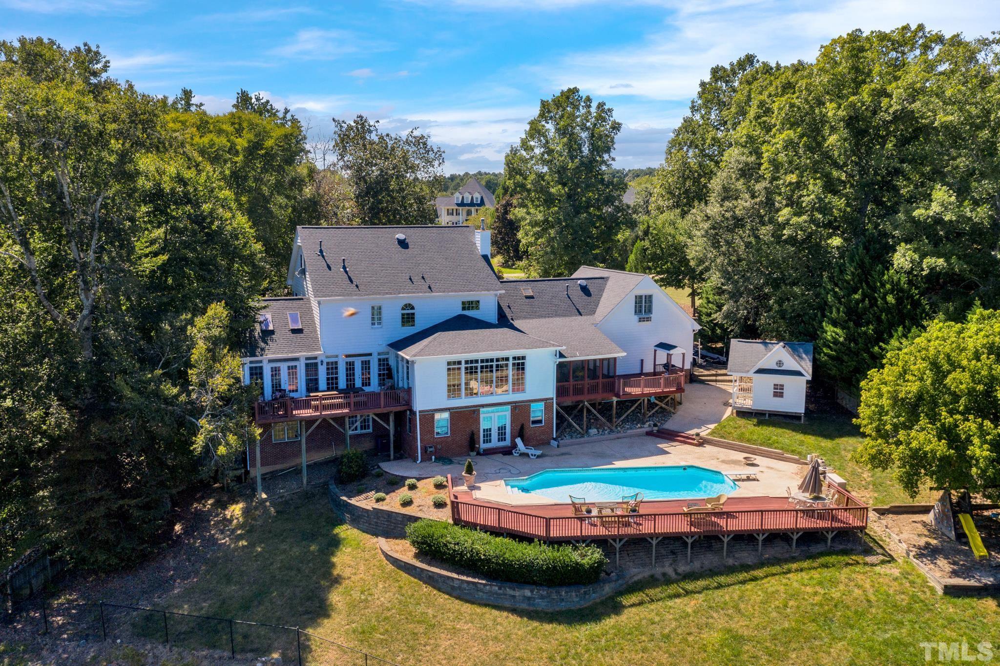 207 Holly Circle Clayton, NC 27527 - Photo 1 of 30 an aerial view of a house with swimming pool and a yard
