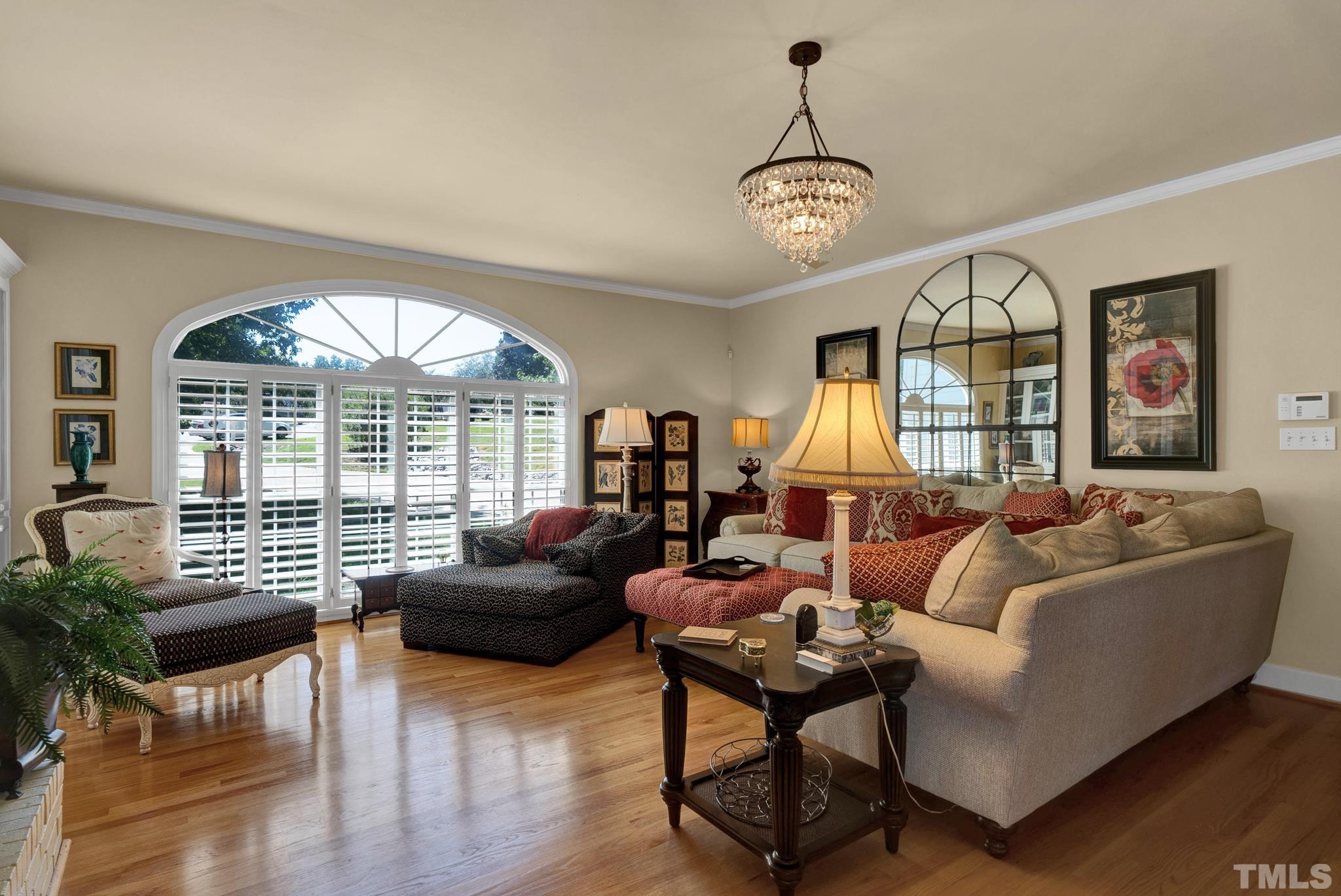 207 Holly Circle Clayton, NC 27527 - Photo 13 of 30 a living room with furniture chandelier and a large window