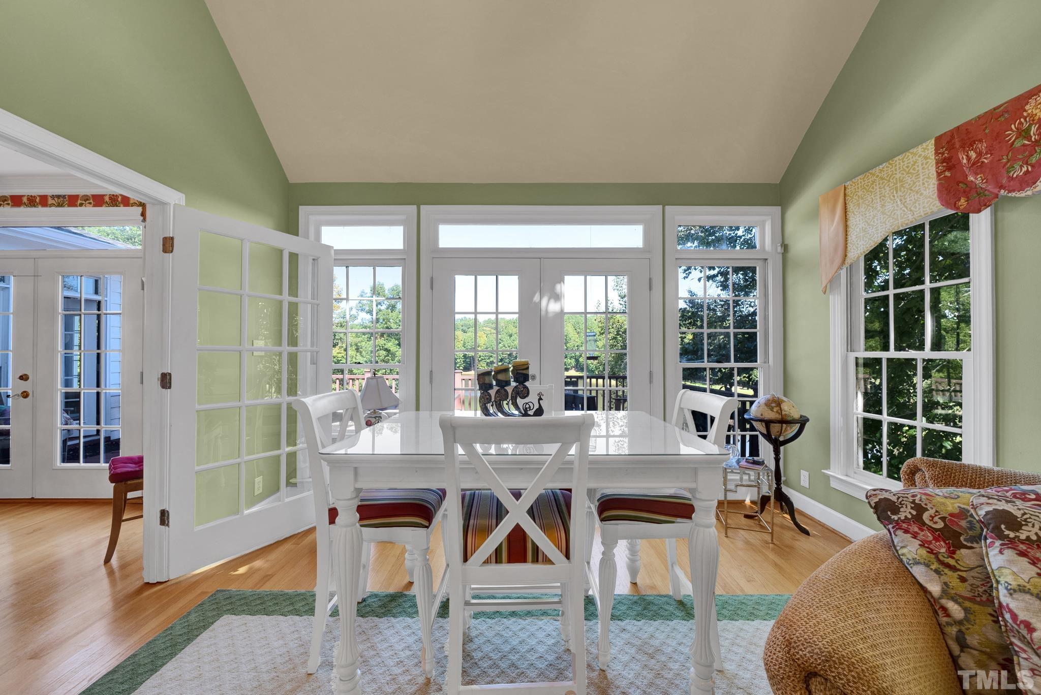 207 Holly Circle Clayton, NC 27527 - Photo 16 of 30 a living room with furniture a flat screen tv and a large window