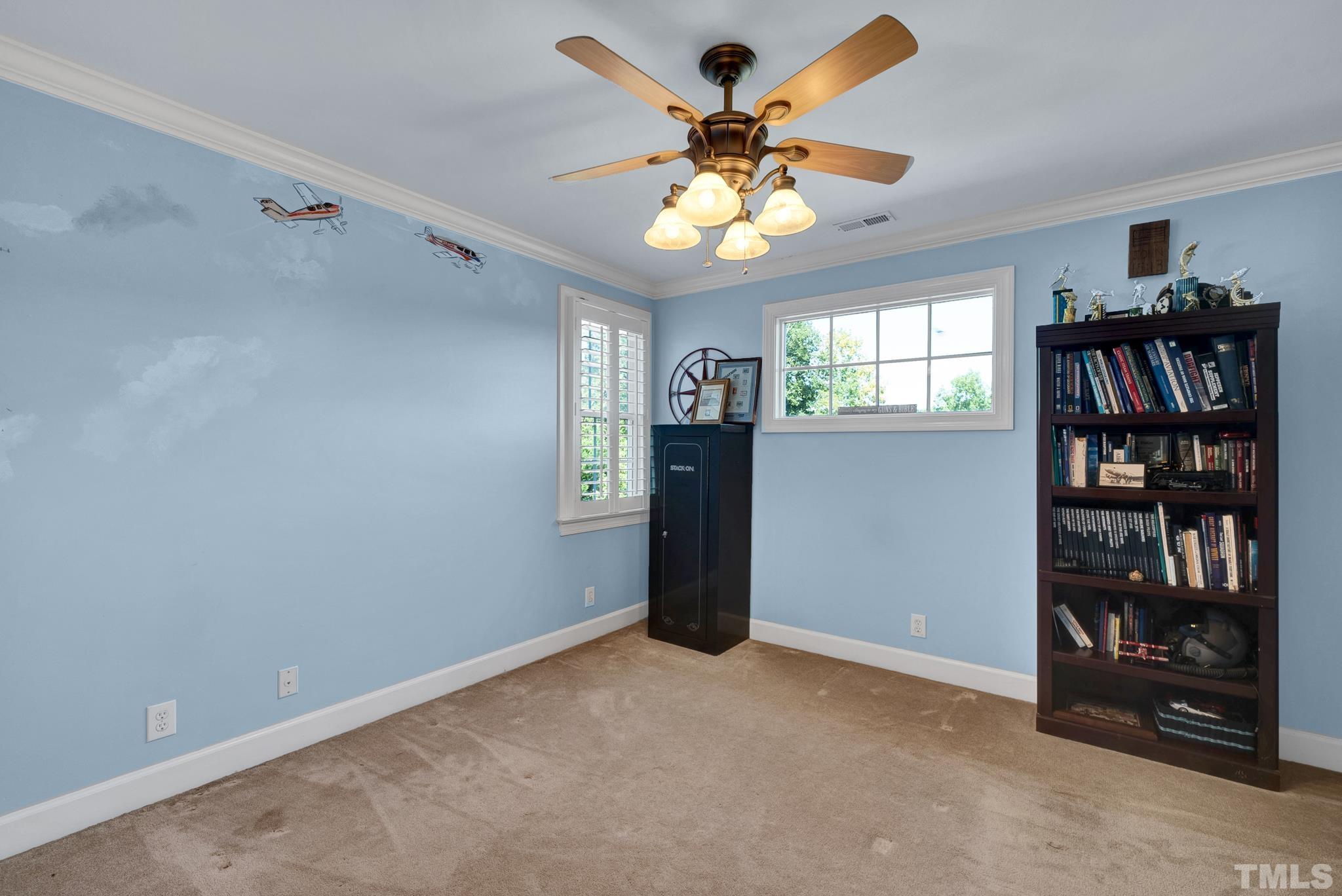207 Holly Circle Clayton, NC 27527 - Photo 23 of 30 a view of an empty room with a window and a chandelier fan