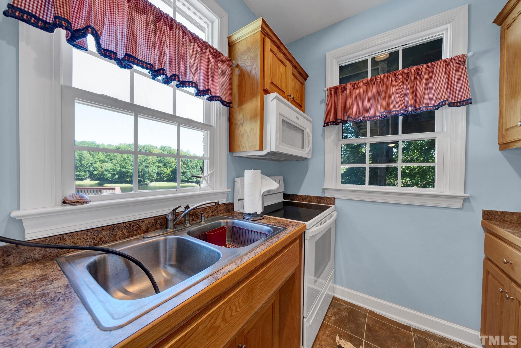 207 Holly Circle Clayton, NC 27527 - Photo 27 of 30 a kitchen that has a sink and a window