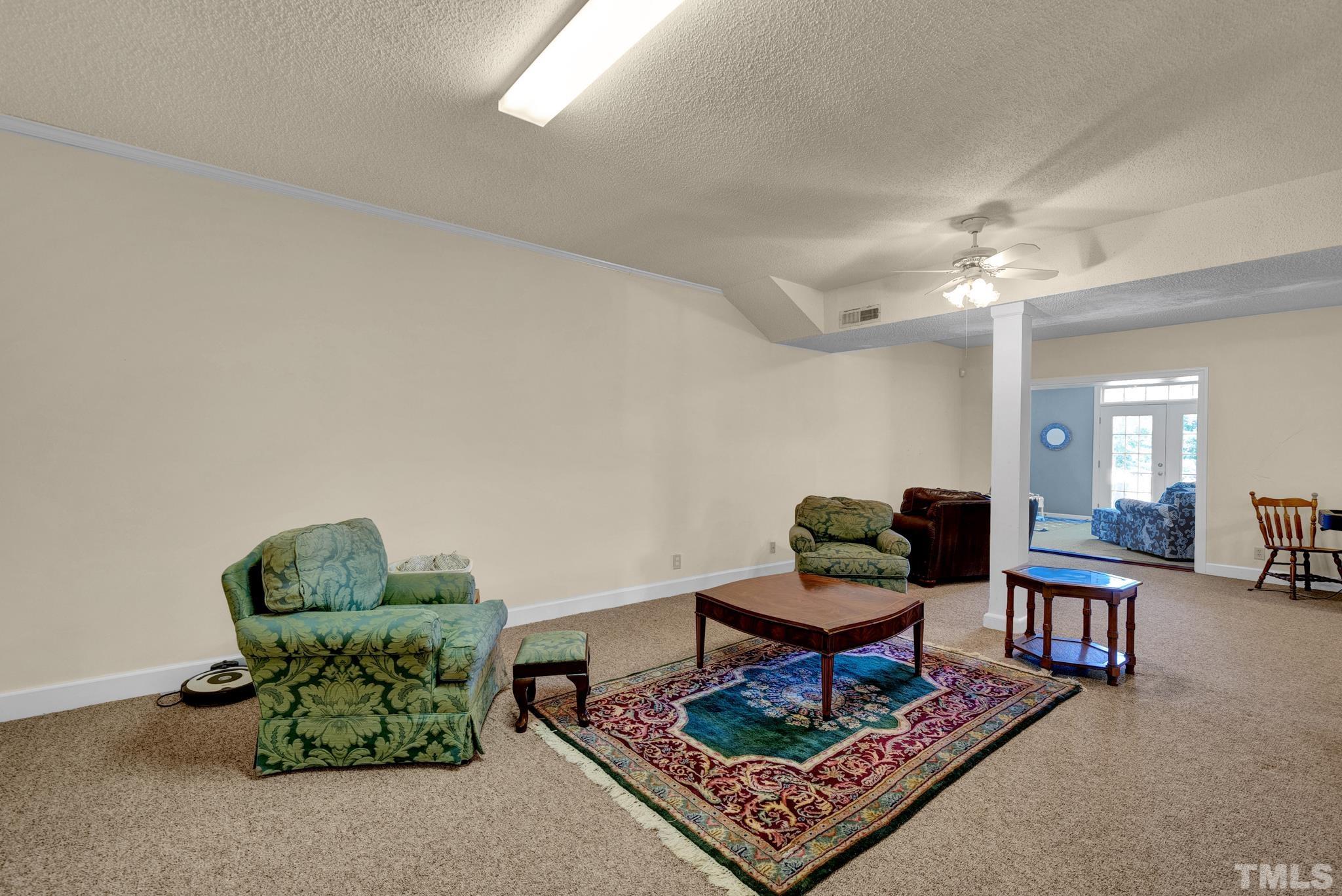 207 Holly Circle Clayton, NC 27527 - Photo 30 of 30 a living room with furniture and a rug