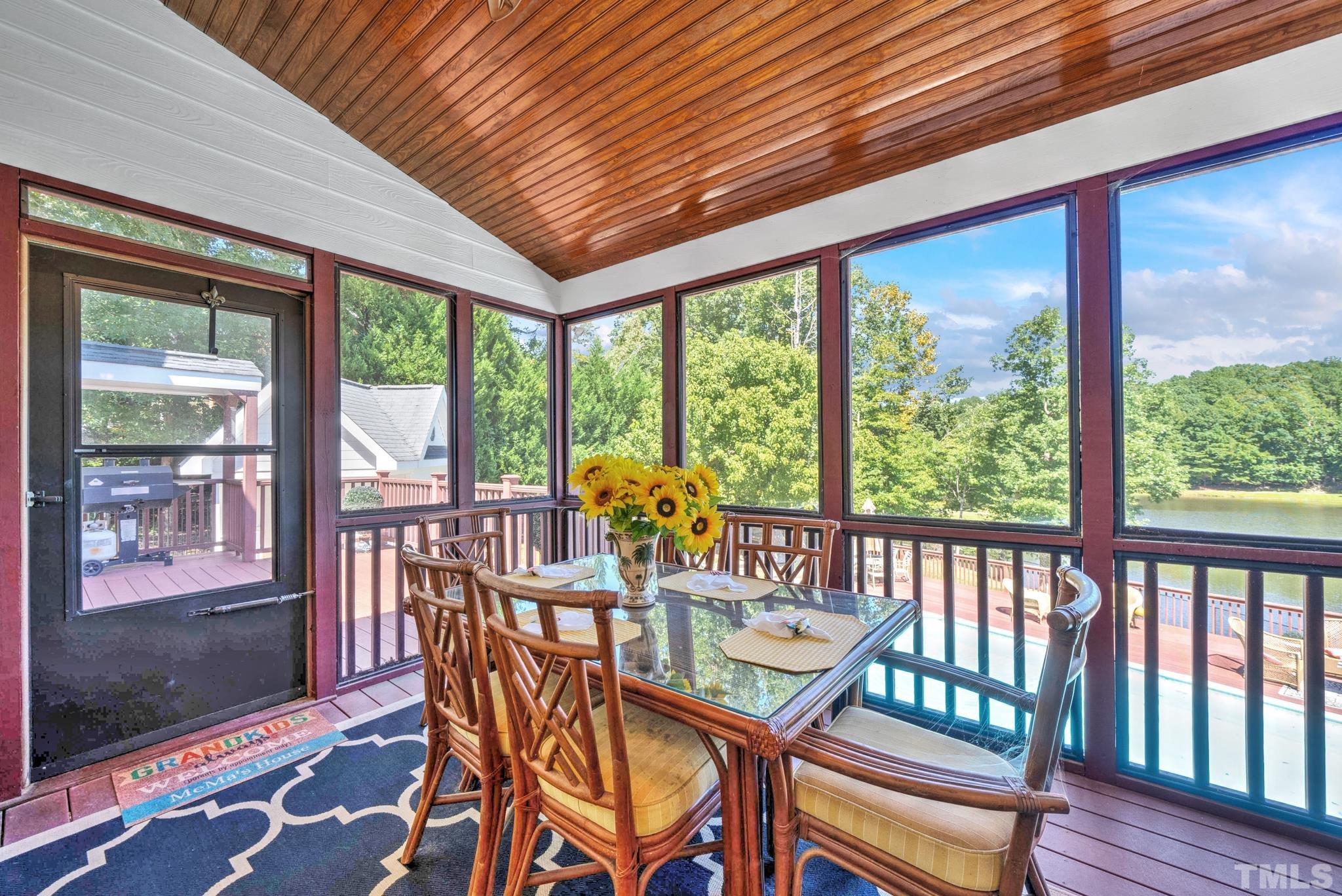 207 Holly Circle Clayton, NC 27527 - Photo 5 of 30 a view of a dining room with furniture large windows and wooden floor