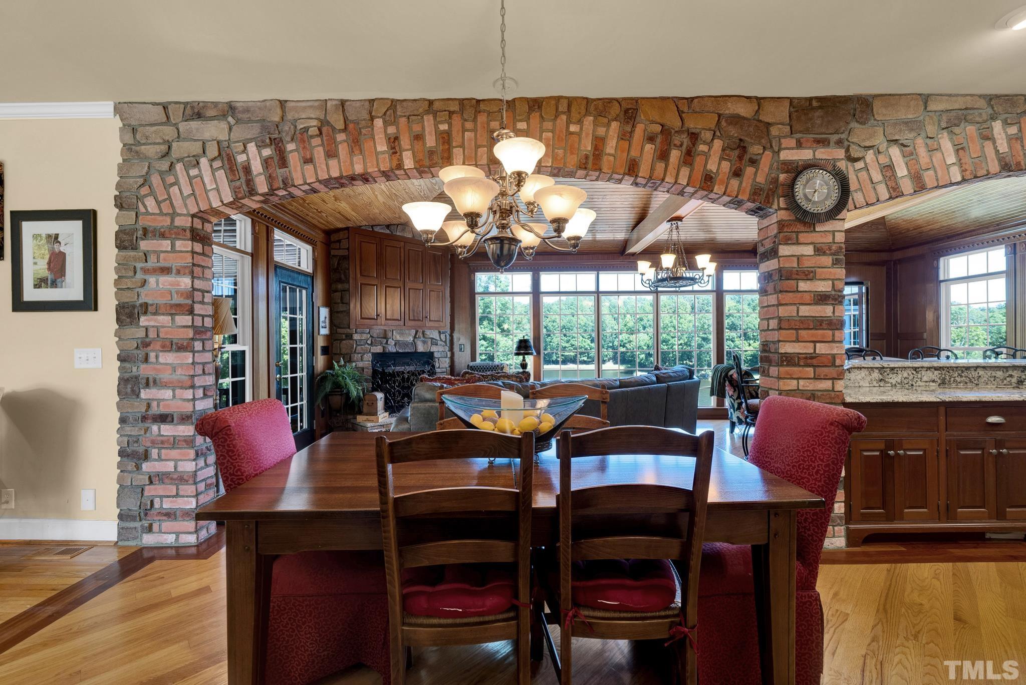 207 Holly Circle Clayton, NC 27527 - Photo 8 of 30 a view of a dining room with furniture a chandelier and wooden floor
