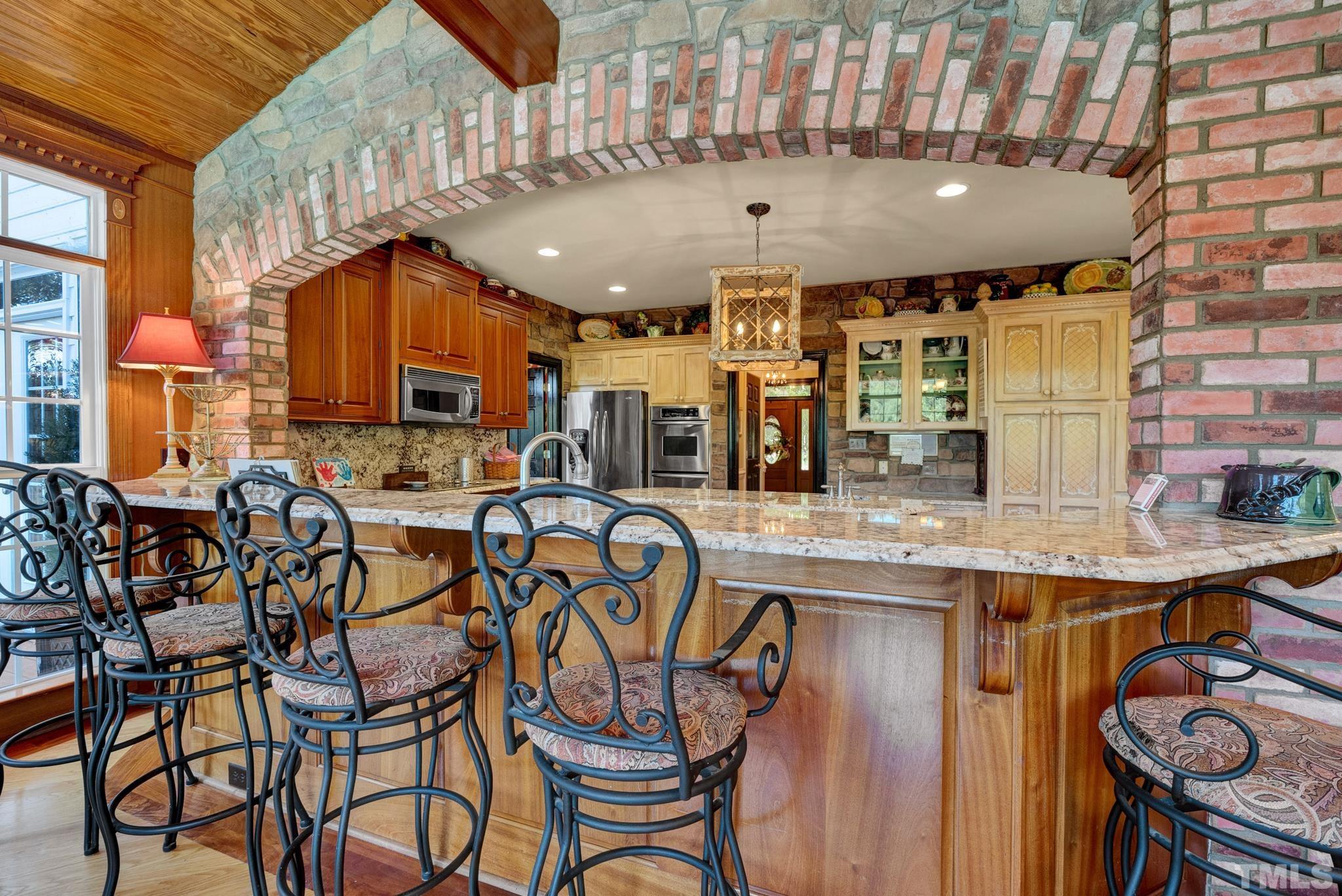 207 Holly Circle Clayton, NC 27527 - Photo 10 of 30 an open kitchen with a table and chairs