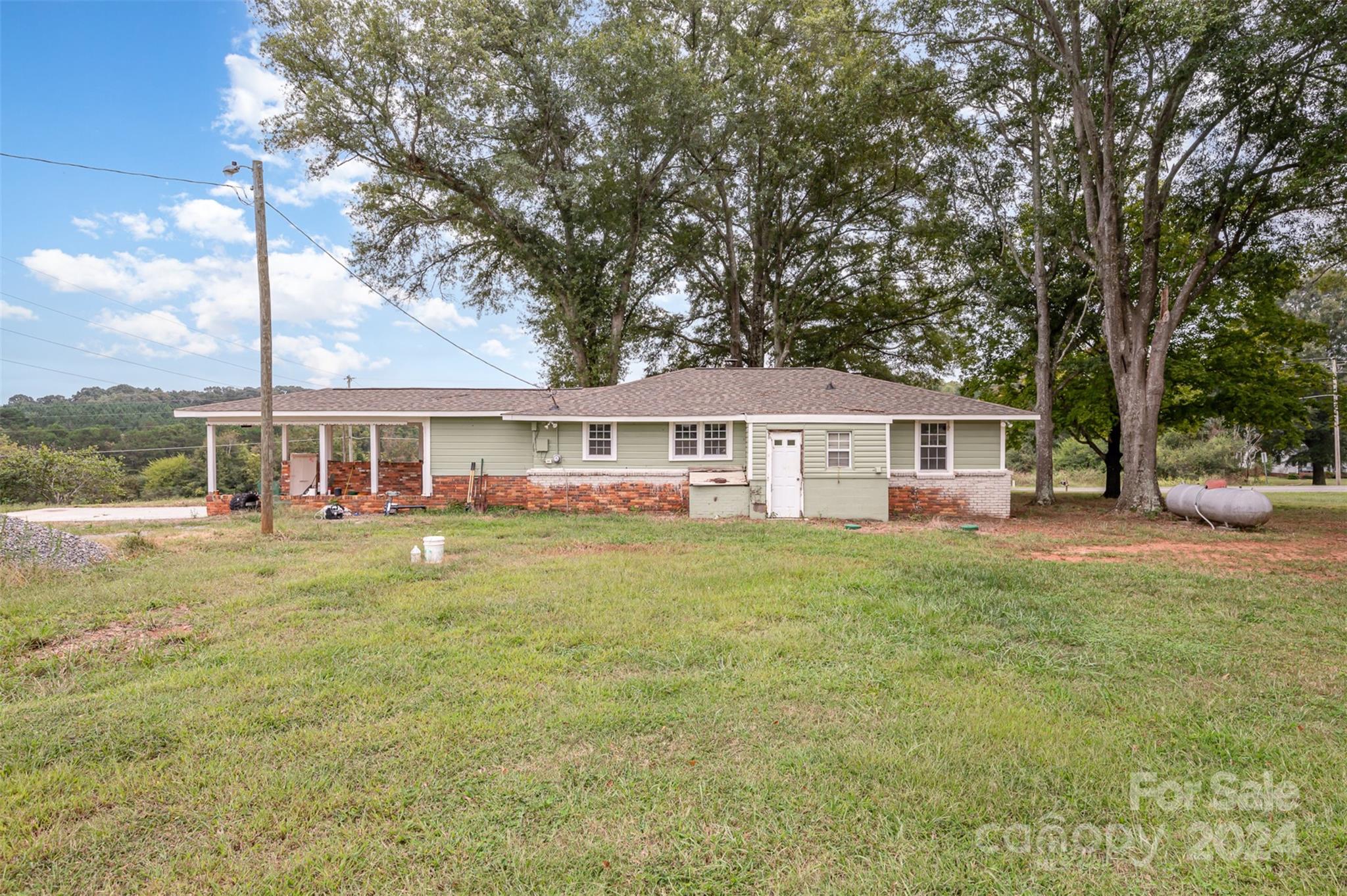 3869 Randleman Road Iron Station, NC 28080 - Photo 2 of 16 a front view of a house with a garden