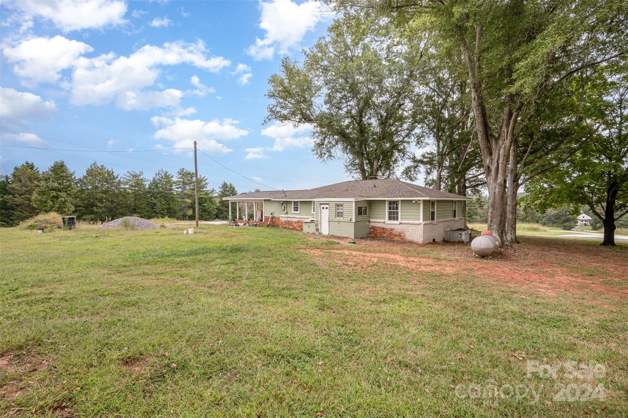 3869 Randleman Road Iron Station, NC 28080 - Photo 4 of 16 a front view of a house with yard and green space