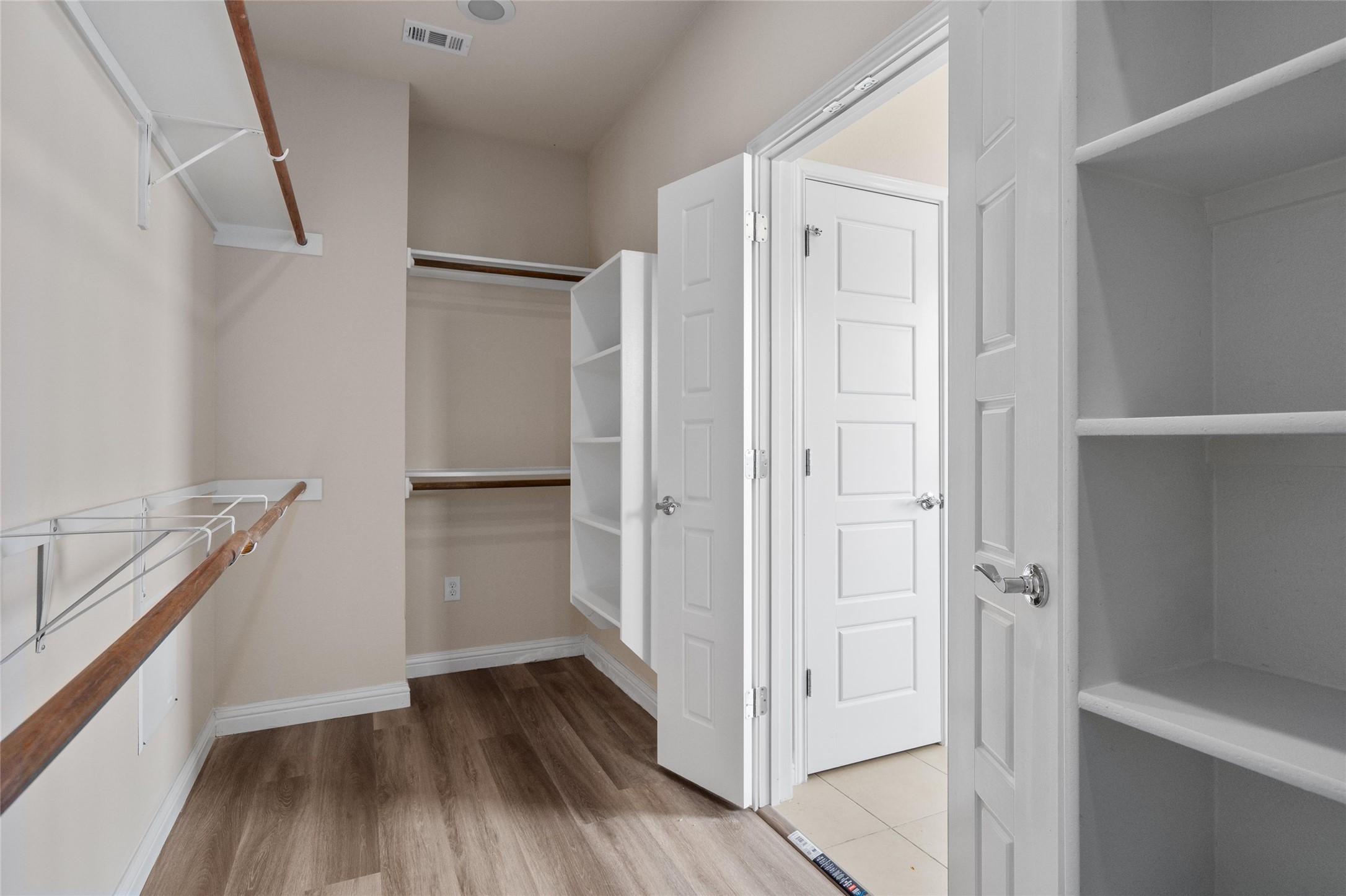 6907 Idea Road Austin, TX 78741 - Photo 21 of 36 a view of walk in closet with wooden floor