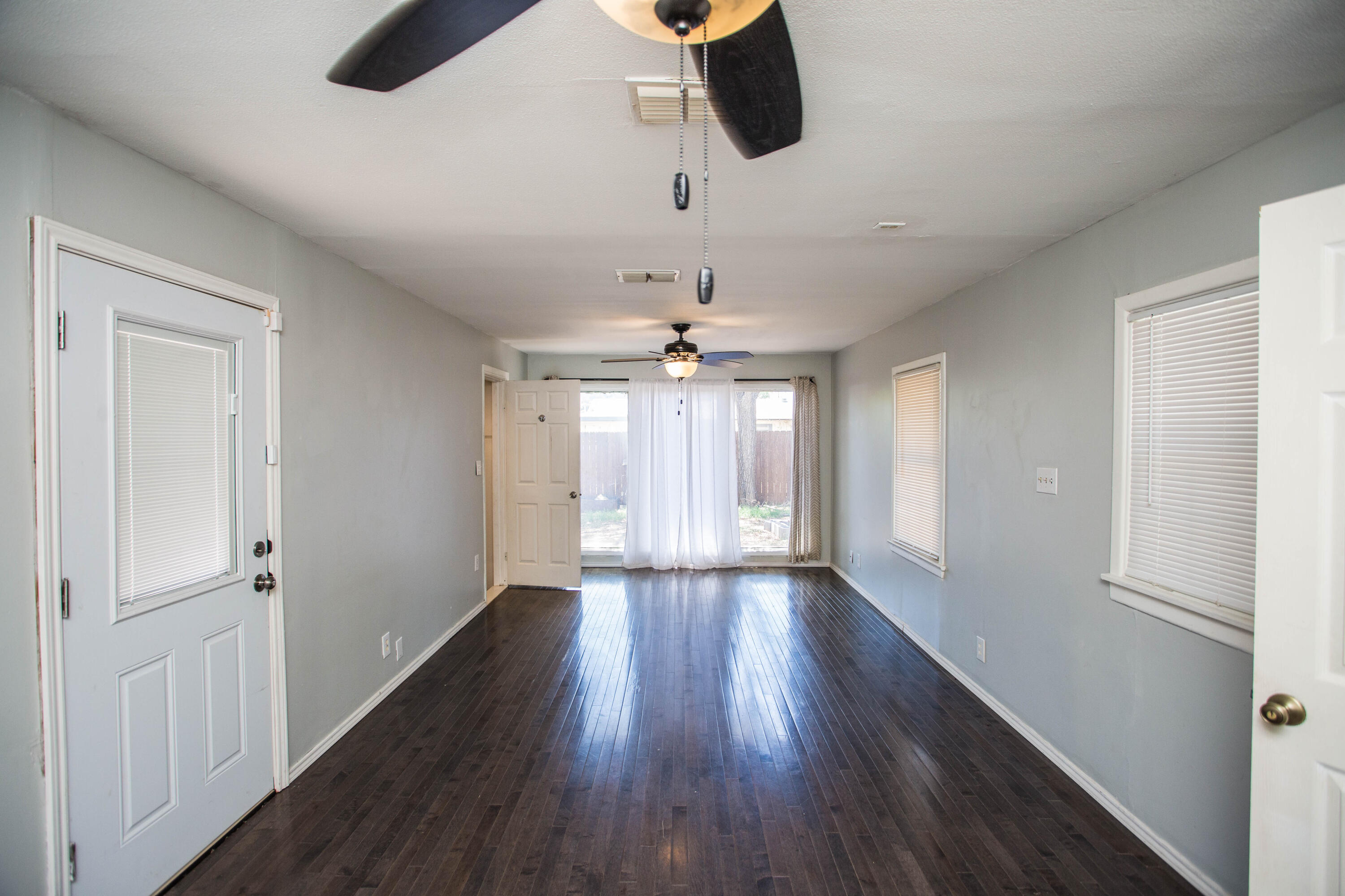 4213 40th Street Lubbock, TX 79413 - Photo 12 of 30 wooden floor in an empty room with a window