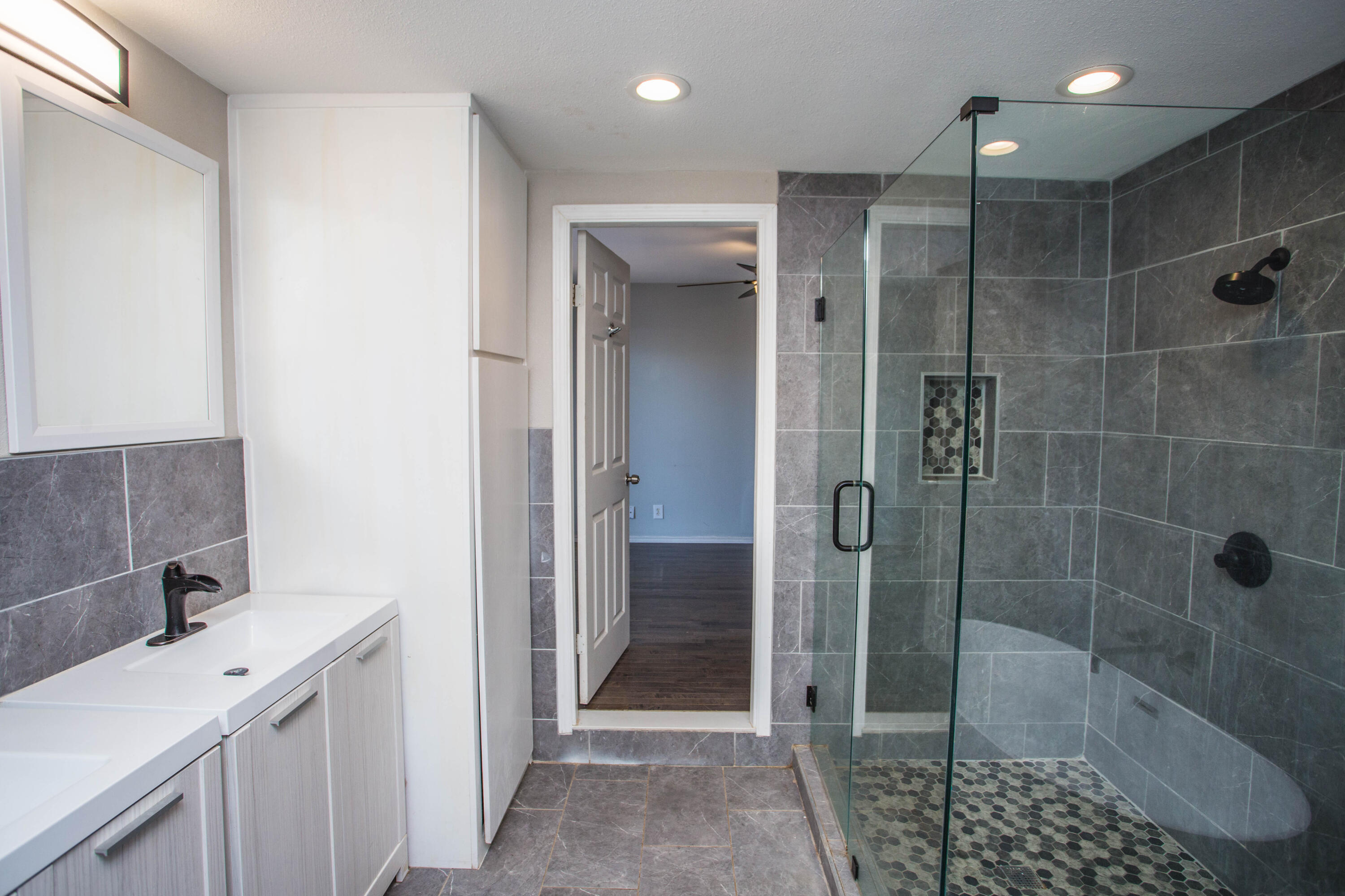 4213 40th Street Lubbock, TX 79413 - Photo 15 of 30 a bathroom with a shower and a sink