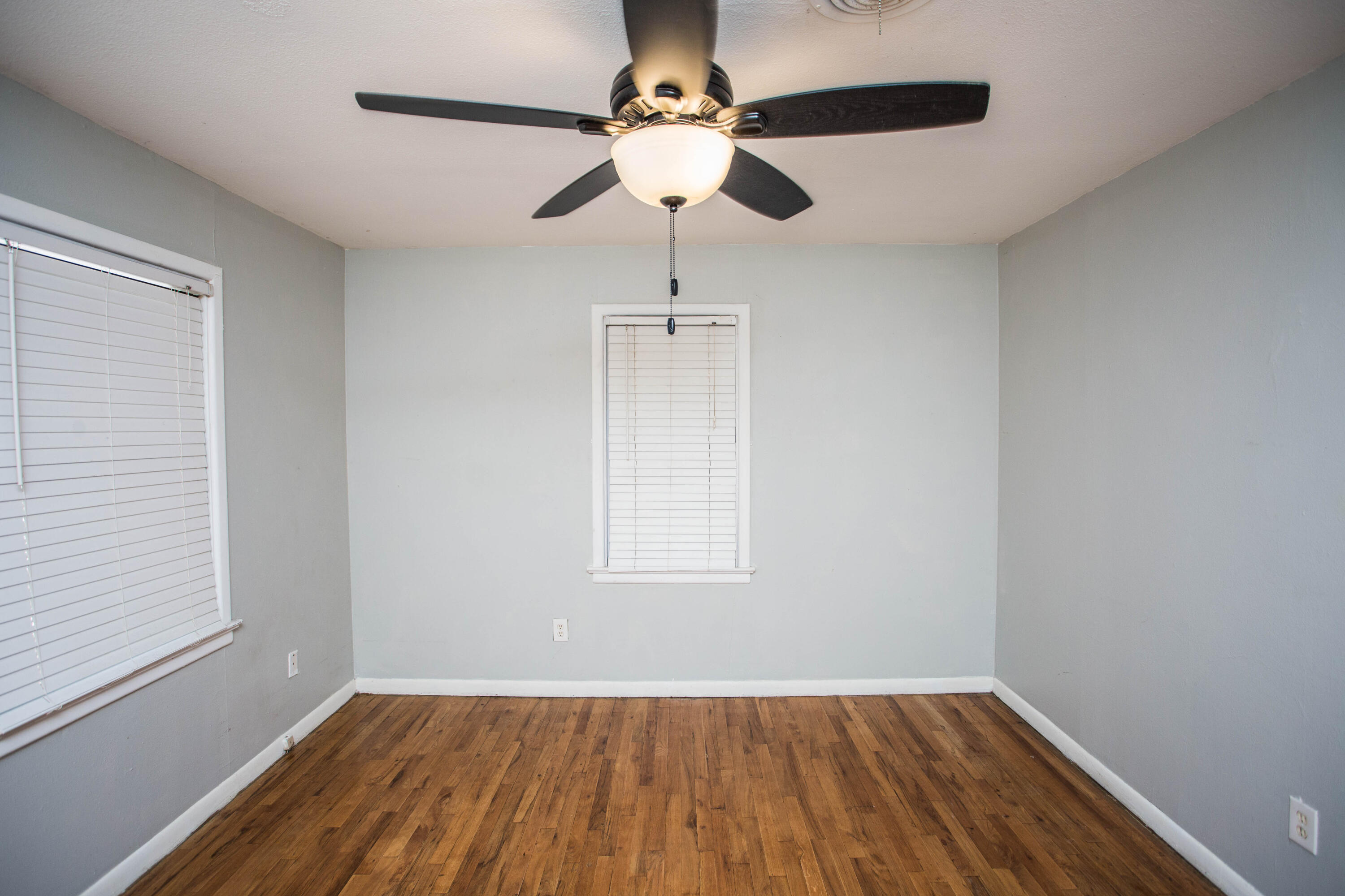 4213 40th Street Lubbock, TX 79413 - Photo 18 of 30 wooden floor in an empty room with a window