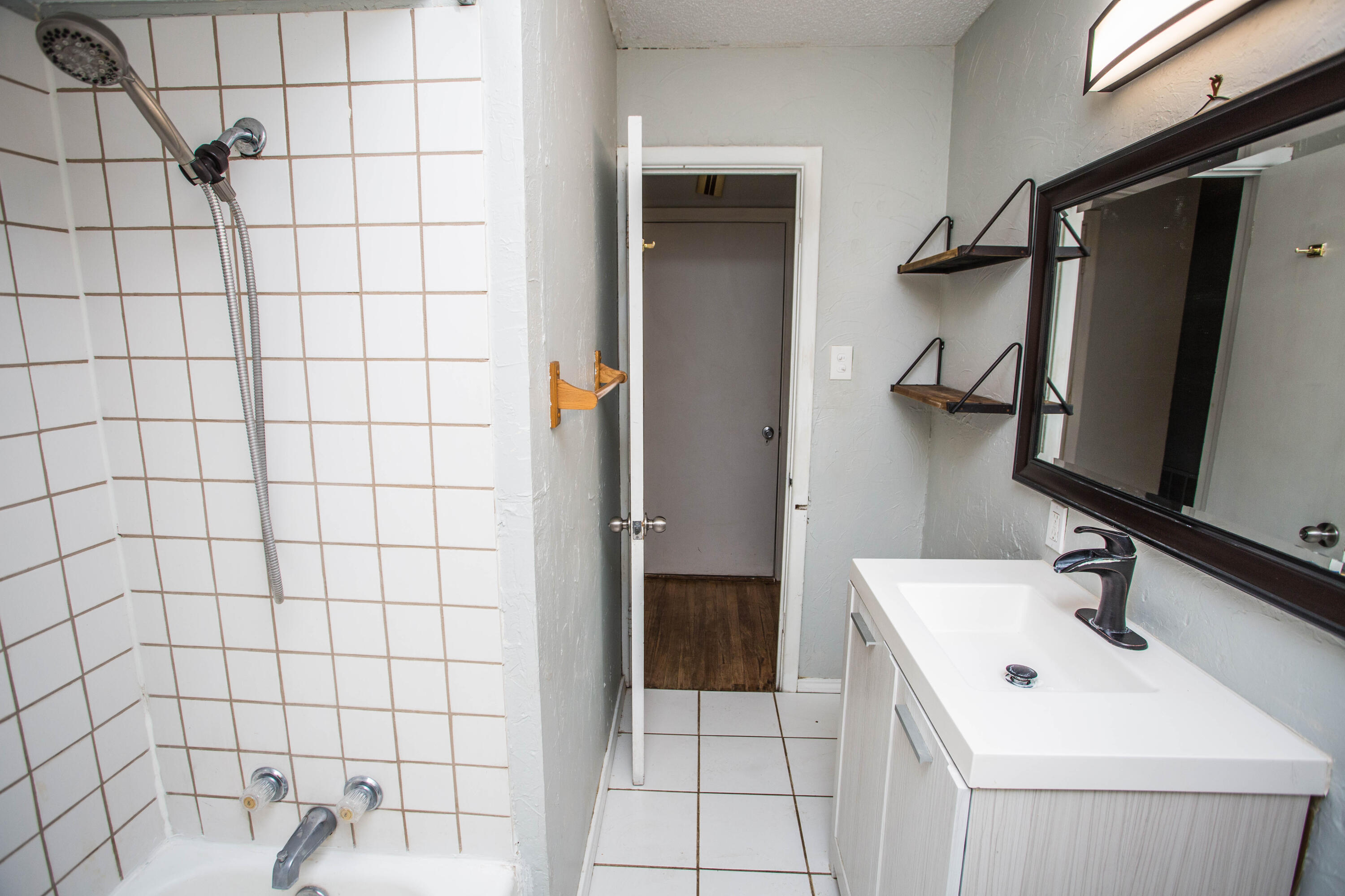 4213 40th Street Lubbock, TX 79413 - Photo 21 of 30 a bathroom with a sink toilet and shower