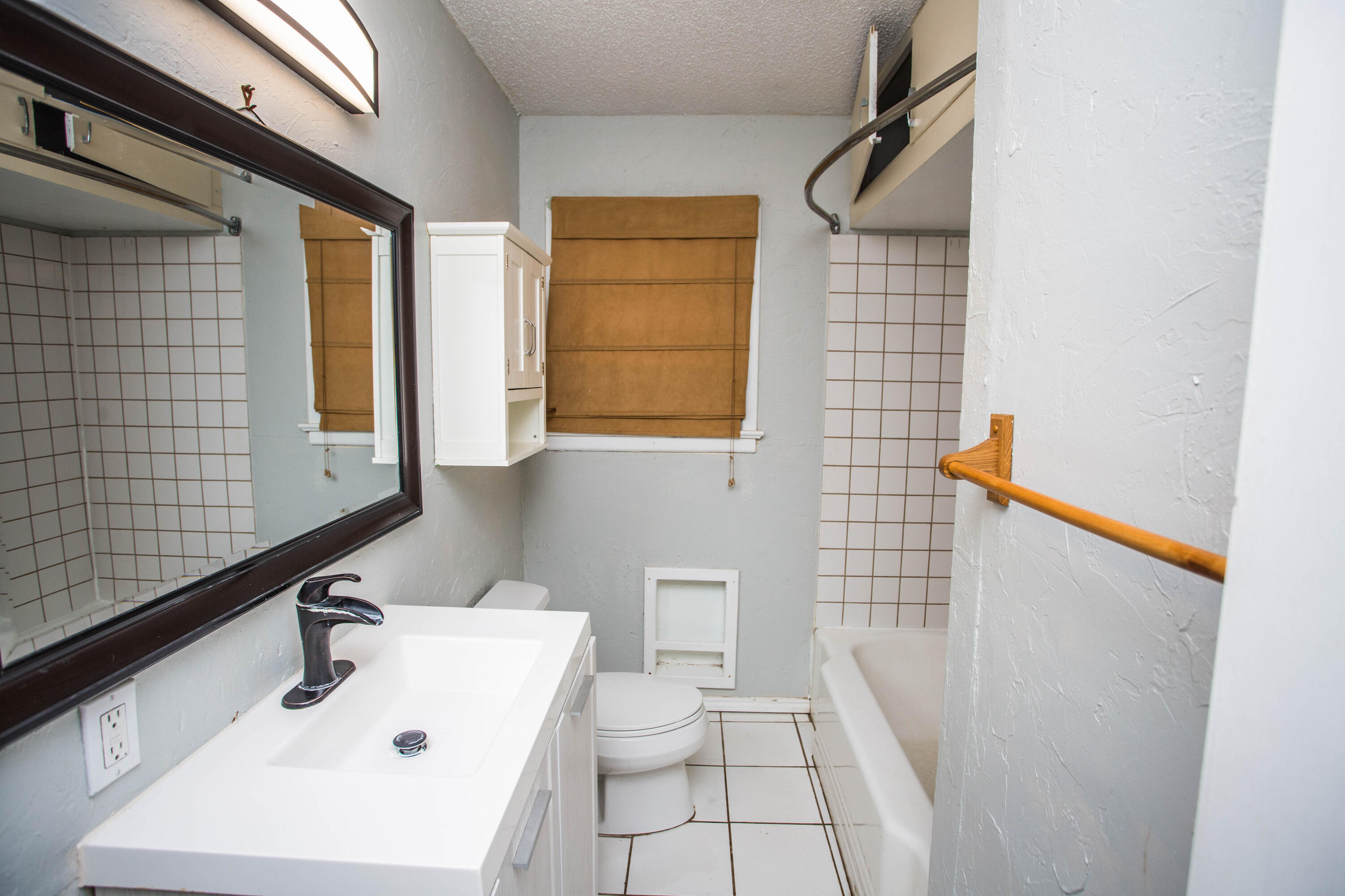 4213 40th Street Lubbock, TX 79413 - Photo 22 of 30 a bathroom with a sink a toilet and shower