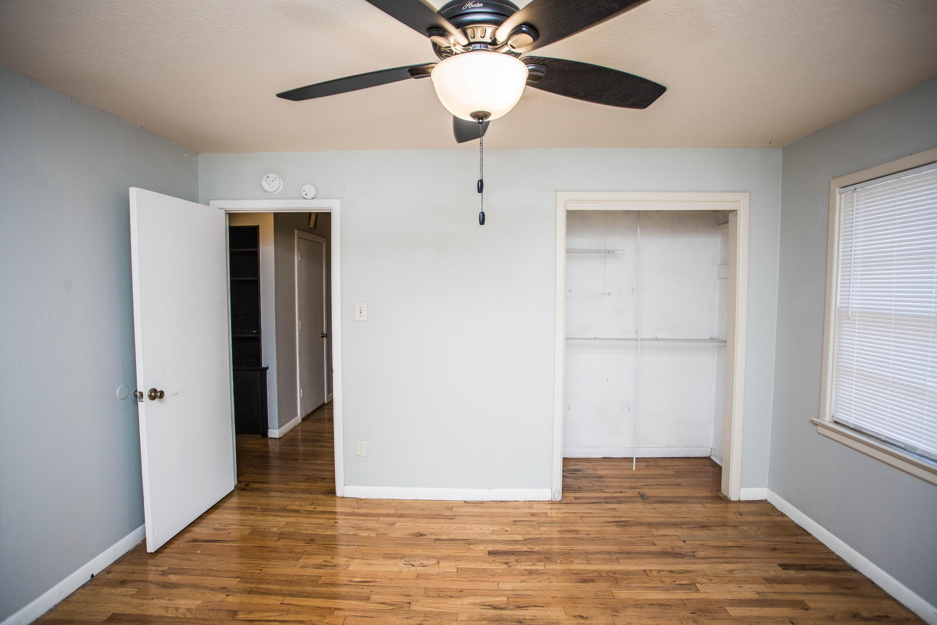 4213 40th Street Lubbock, TX 79413 - Photo 25 of 30 a view of an empty room with wooden floor and a window