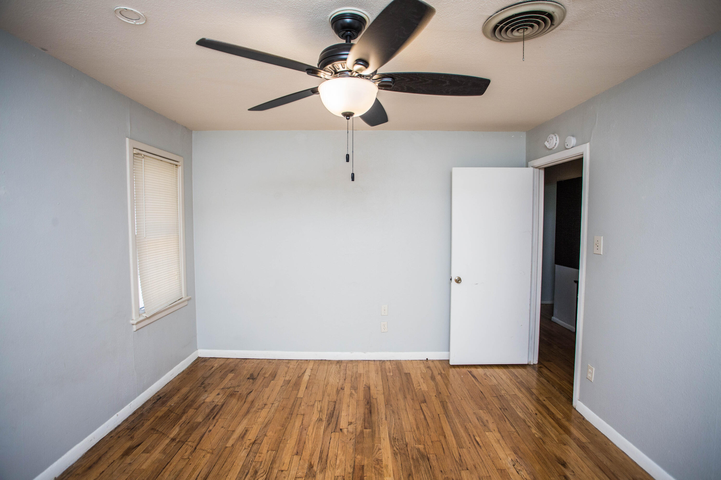 4213 40th Street Lubbock, TX 79413 - Photo 26 of 30 wooden floor in an empty room with a window