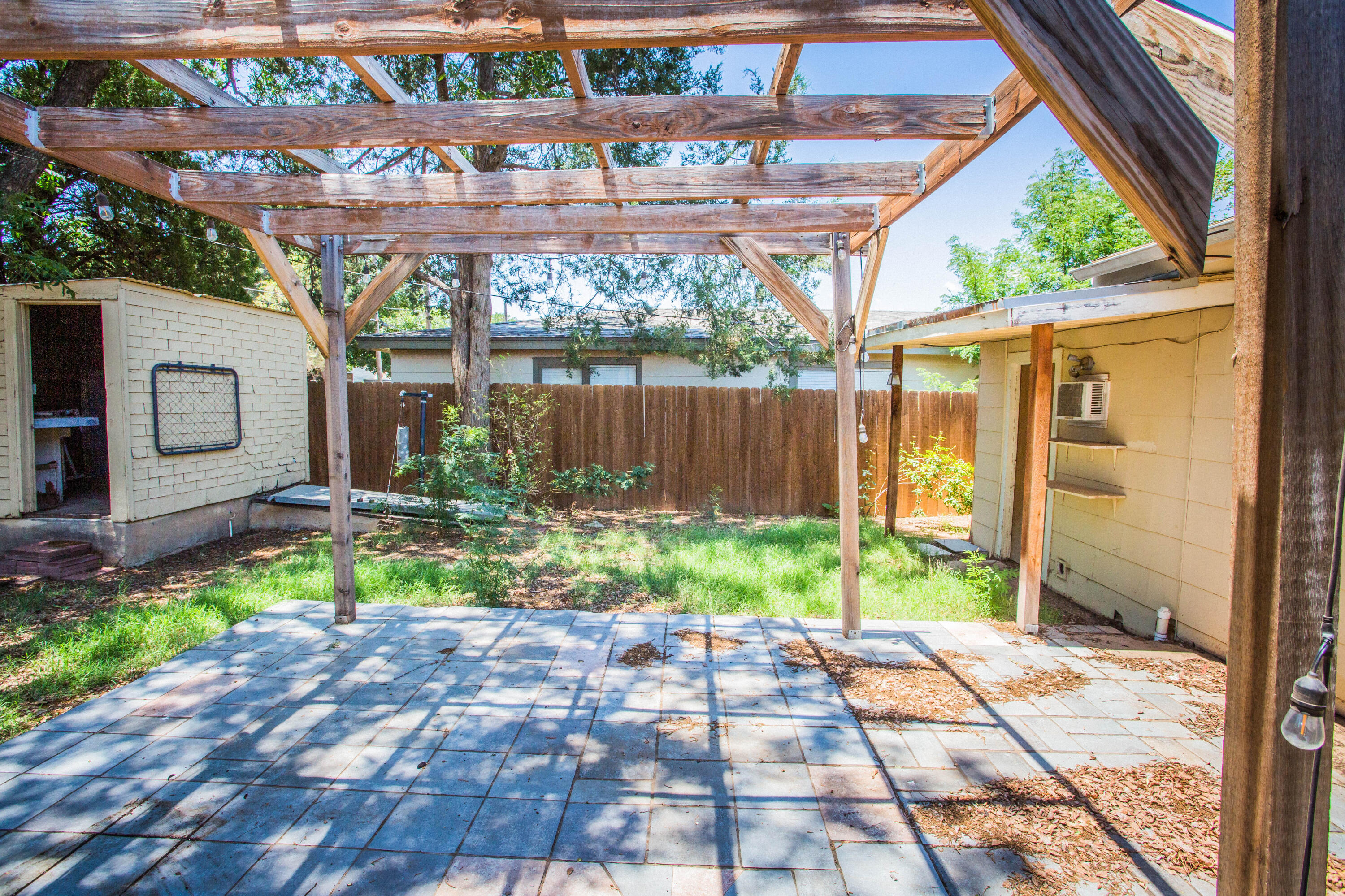 4213 40th Street Lubbock, TX 79413 - Photo 27 of 30 a backyard of a house with yard and outdoor seating