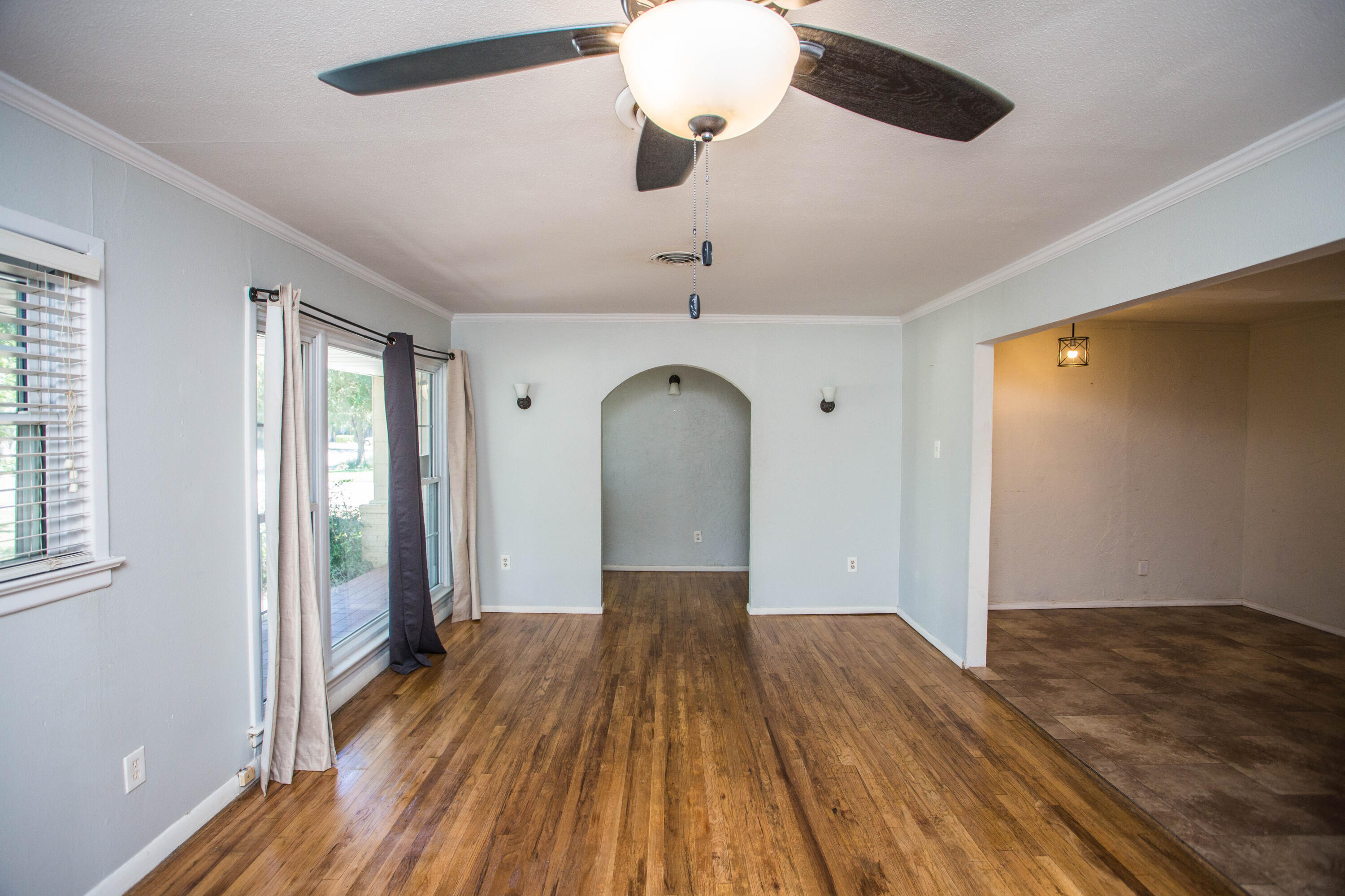 4213 40th Street Lubbock, TX 79413 - Photo 4 of 30 a view of a room with wooden floor fan and windows