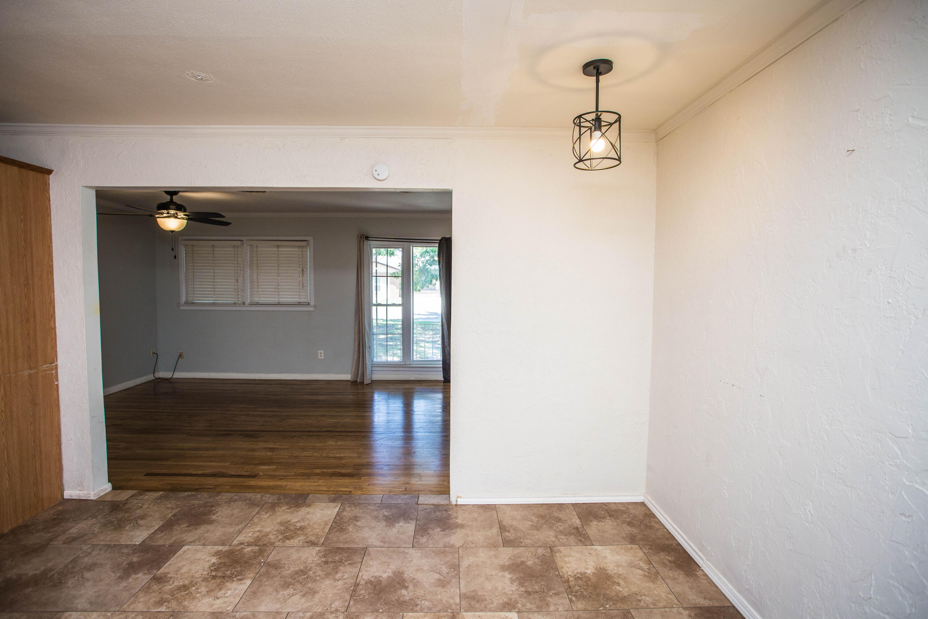 4213 40th Street Lubbock, TX 79413 - Photo 7 of 30 a view of empty room with wooden floor and fan