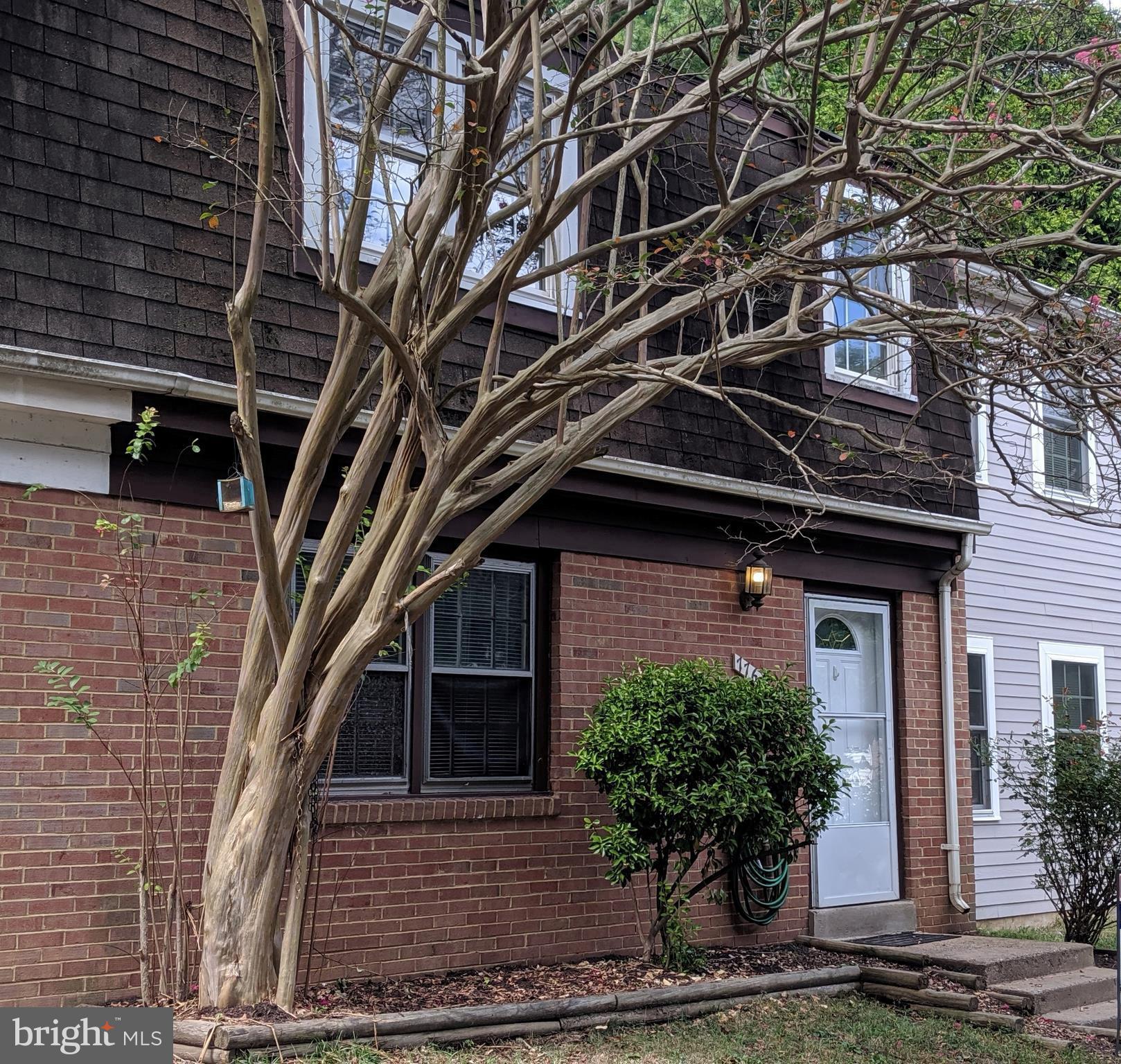 7760 Matisse Way Springfield, VA 22153 - Photo 1 of 21 a front view of a house with garden