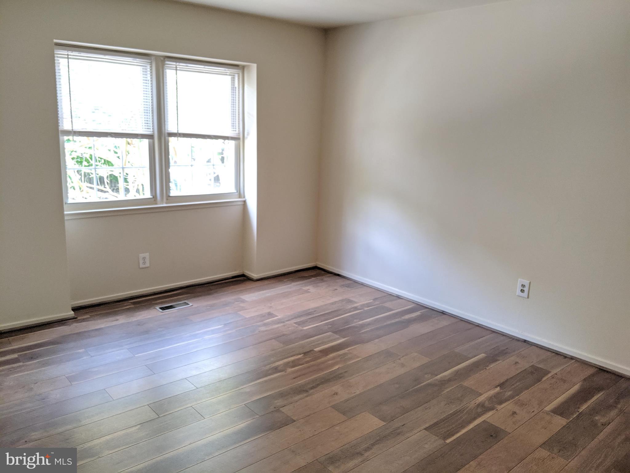 7760 Matisse Way Springfield, VA 22153 - Photo 17 of 21 an empty room with wooden floor and windows