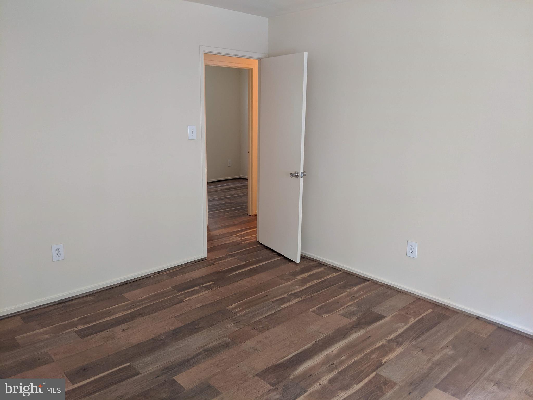 7760 Matisse Way Springfield, VA 22153 - Photo 18 of 21 a view of an empty room with wooden floor