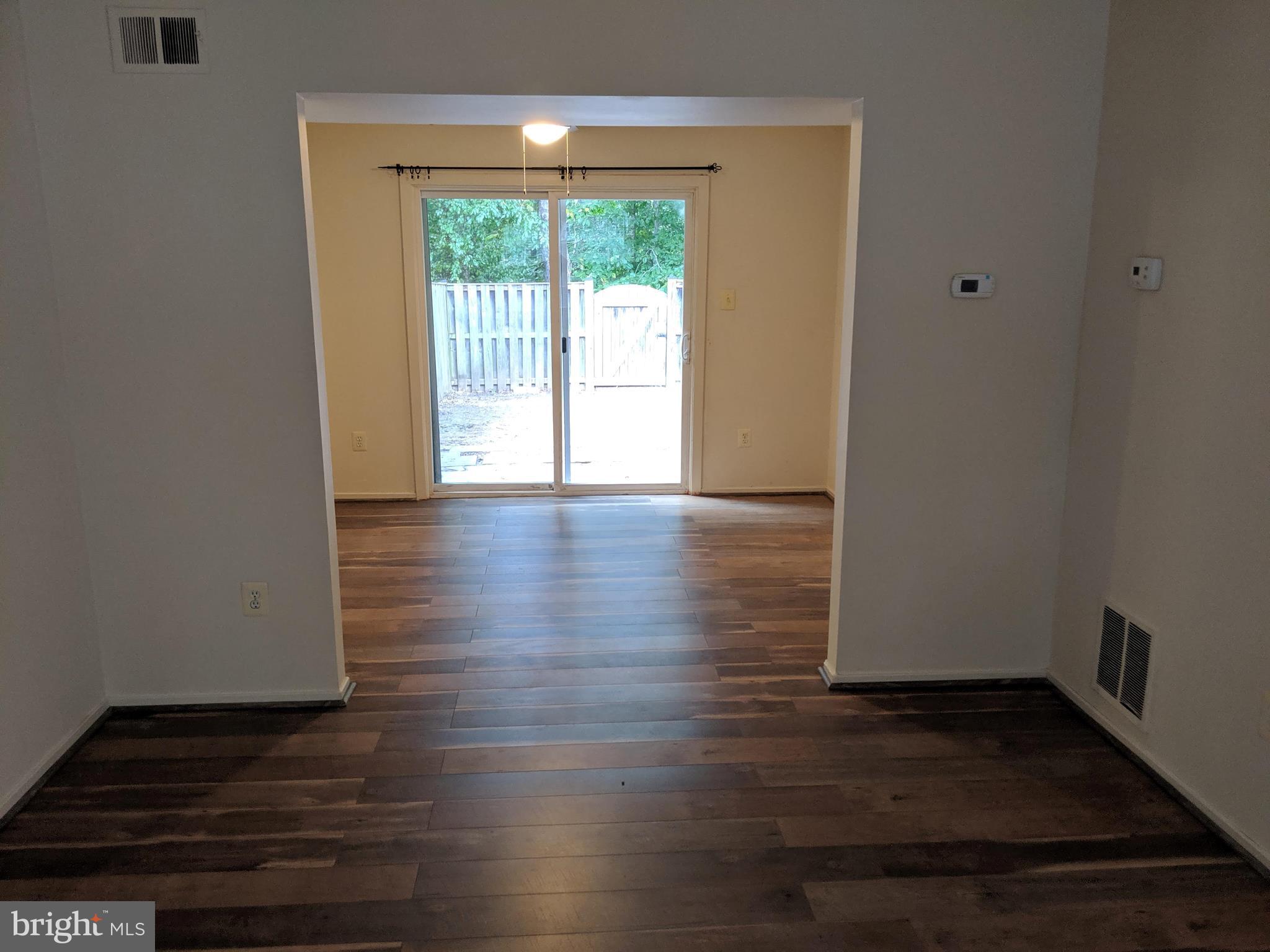7760 Matisse Way Springfield, VA 22153 - Photo 6 of 21 a view of an empty room with wooden floor and a window