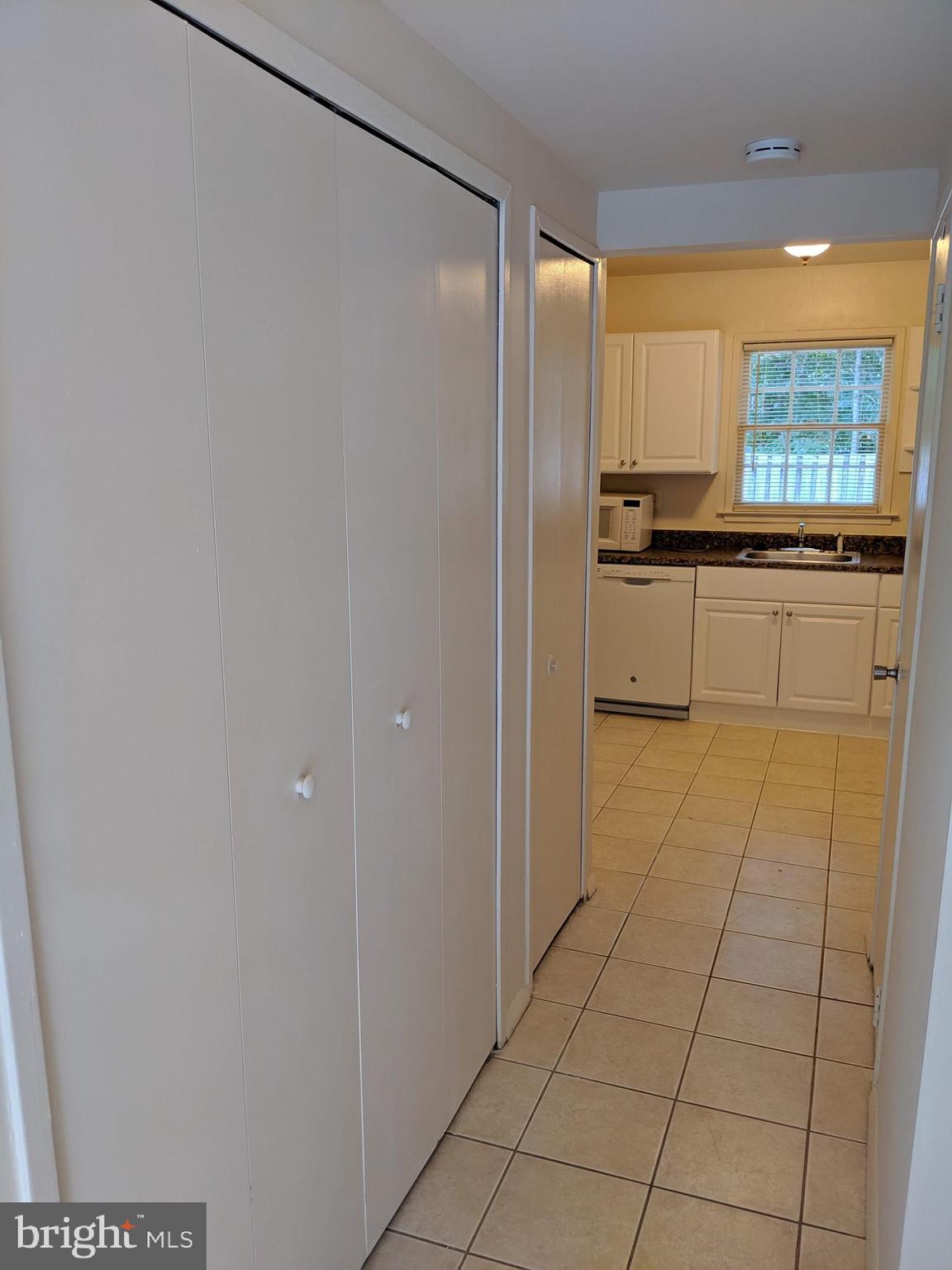 7760 Matisse Way Springfield, VA 22153 - Photo 7 of 21 a view of a kitchen with kitchen island granite countertop a refrigerator a stove a sink and a window