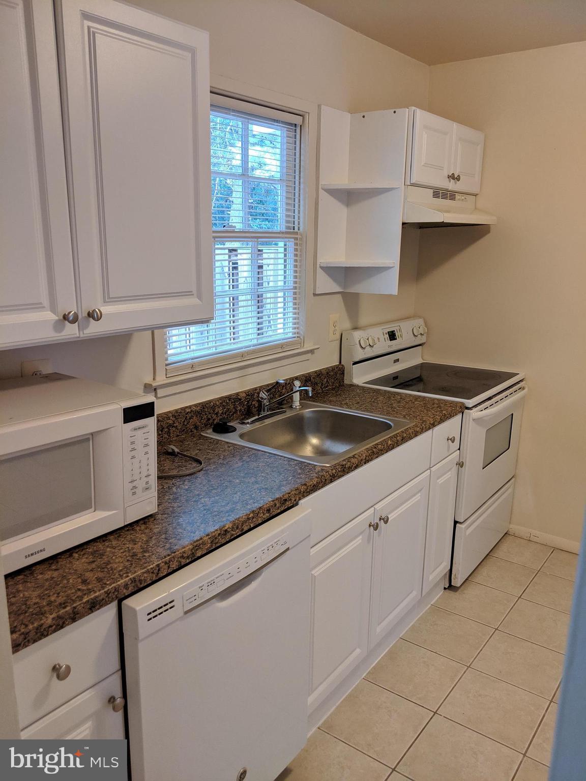 7760 Matisse Way Springfield, VA 22153 - Photo 9 of 21 a kitchen with granite countertop white cabinets and a sink