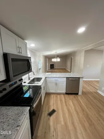 a kitchen with a stove a sink and a refrigerator