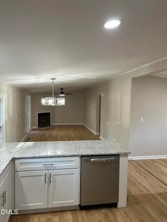 a view living room with granite countertop kitchen island a stove and a sink