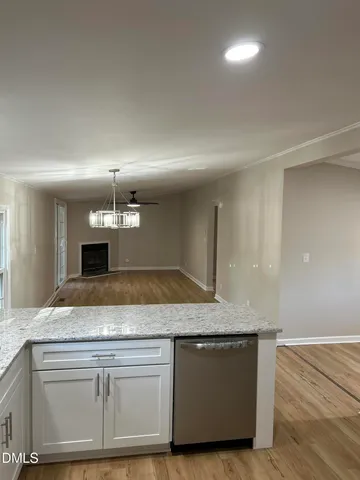 a view living room with granite countertop kitchen island a stove and a sink