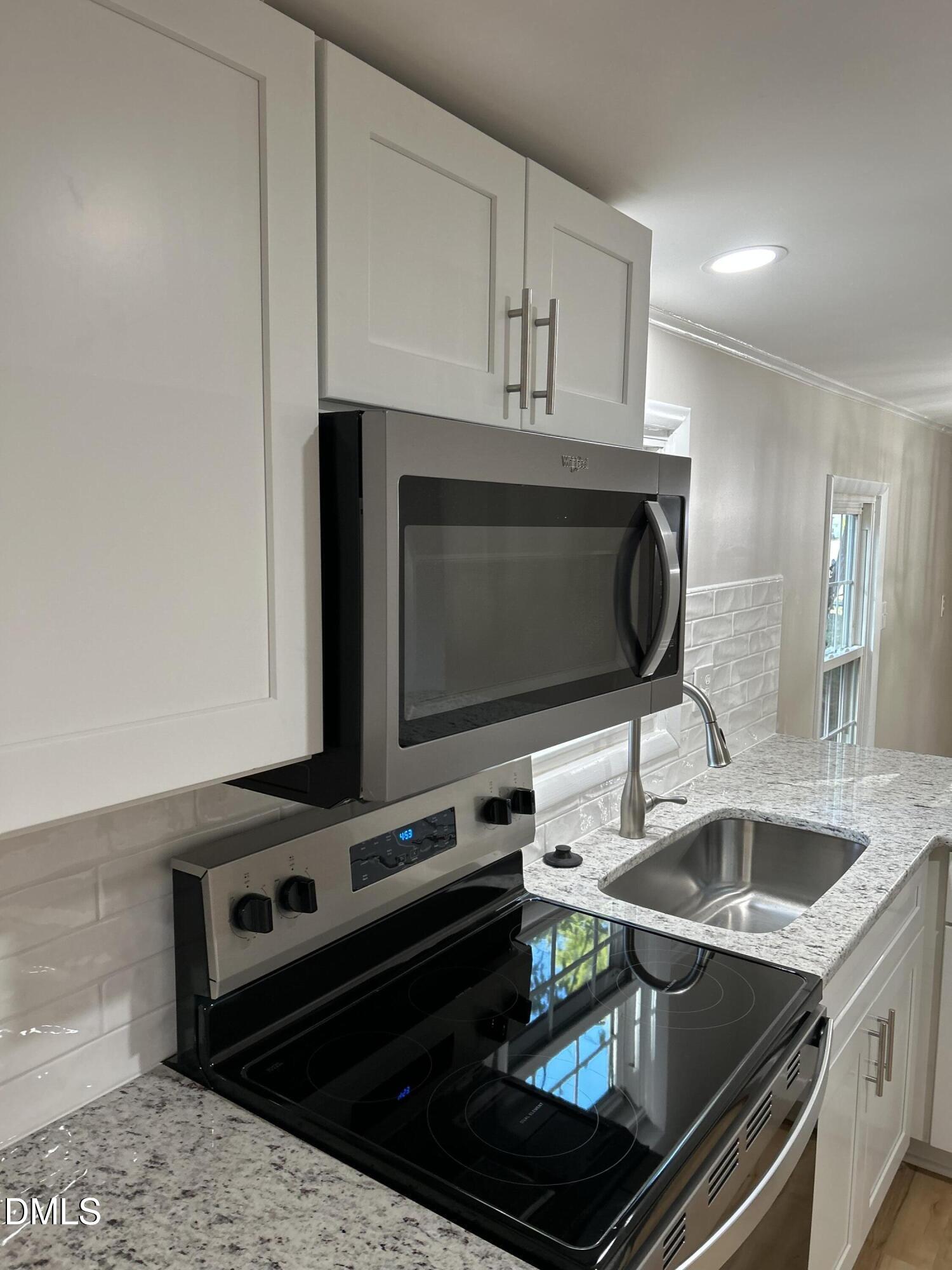 223 7th Street Wake Forest, NC 27587 - Photo 4 of 9 a kitchen with a stove and a microwave