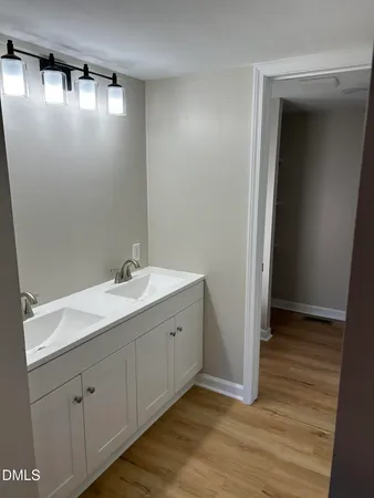 a spacious bathroom with a double vanity sink and a mirror