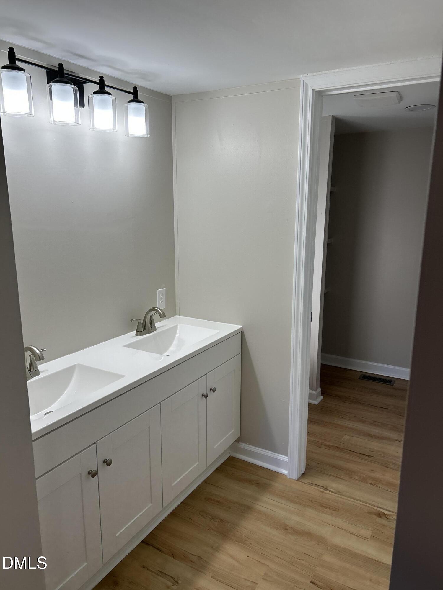 223 7th Street Wake Forest, NC 27587 - Photo 6 of 9 a spacious bathroom with a double vanity sink and a mirror