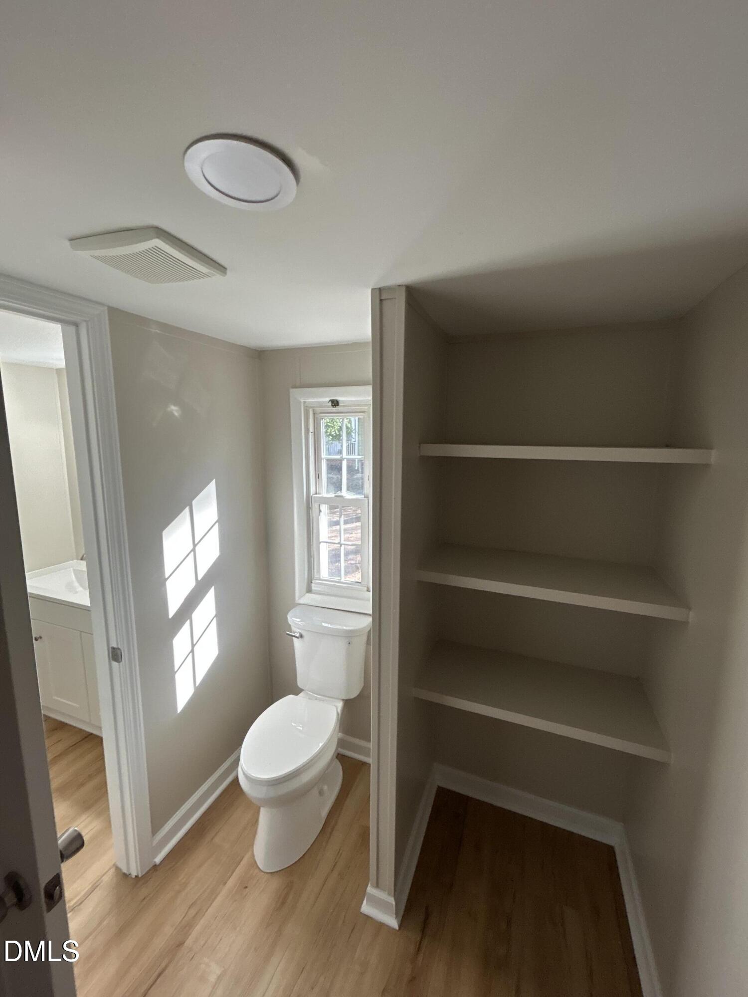 223 7th Street Wake Forest, NC 27587 - Photo 8 of 9 a bathroom with a toilet sink a window and a mirror