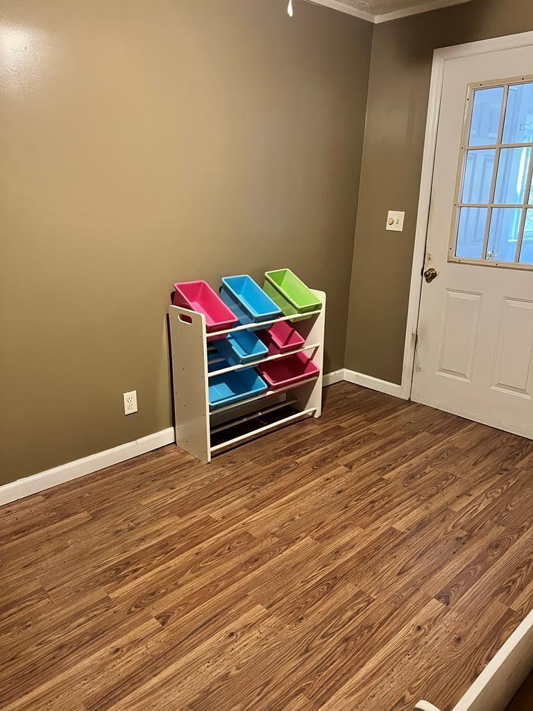 2034 Old River Road Charleston, TN 37310 - Photo 19 of 29 a room with wooden floor and furniture