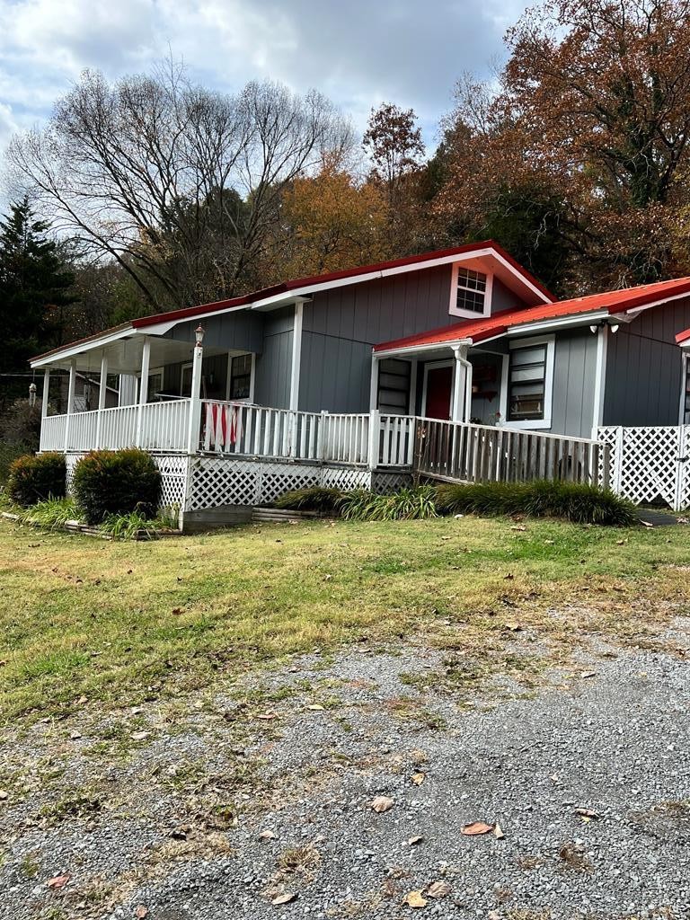 2034 Old River Road Charleston, TN 37310 - Photo 3 of 29 a front view of a house with a garden