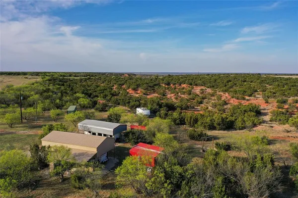 an aerial view of a house with a yard