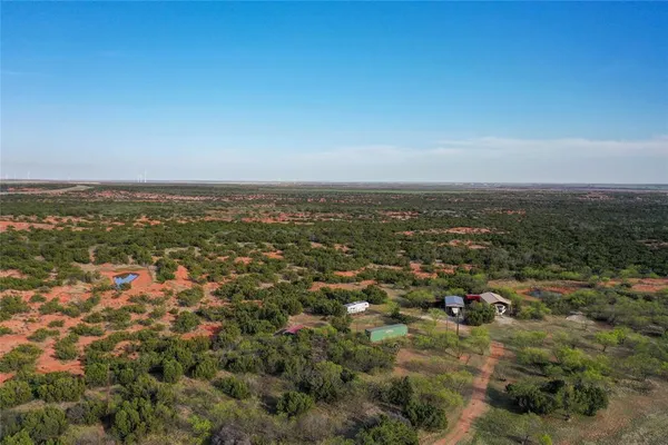 an aerial view of residential houses with city view