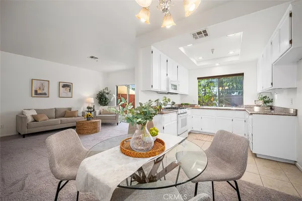 a living room with furniture kitchen and a window