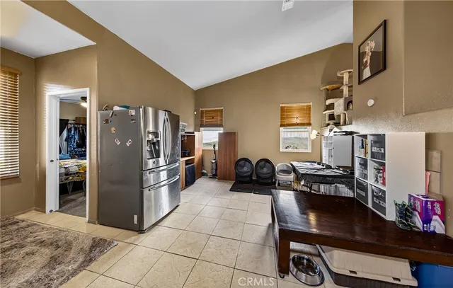a kitchen with refrigerator and cabinets