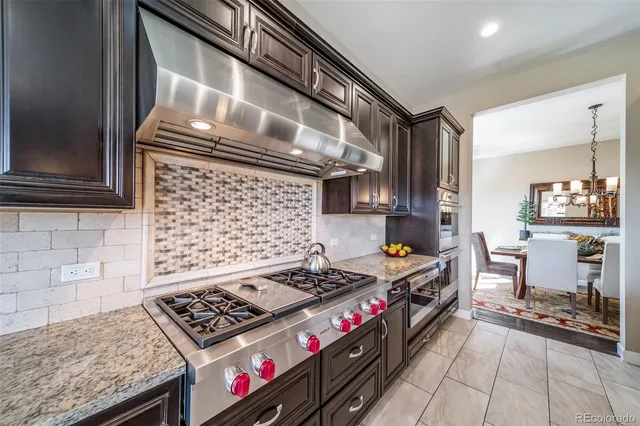 a kitchen with stove and cabinets