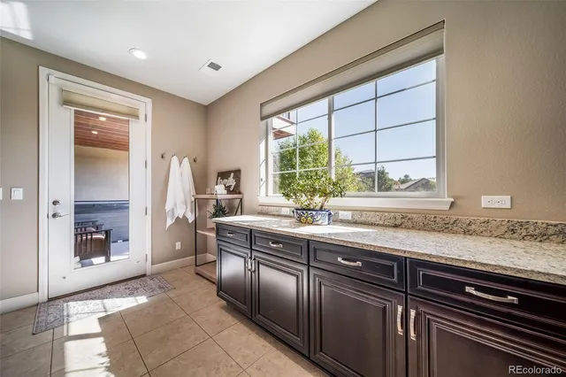 a kitchen with stainless steel appliances granite countertop a sink and a refrigerator