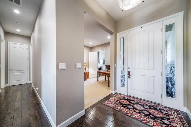 a view of a hallway view with wooden floor and furniture